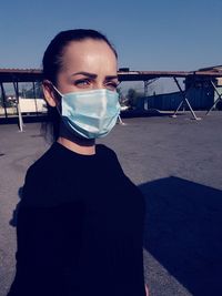 Portrait of young woman against clear sky 