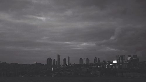 Cityscape against storm clouds