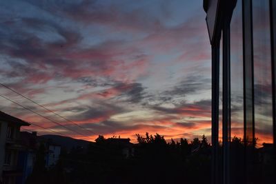 Silhouette buildings against sky during sunset