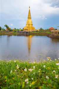 Temple by building against sky