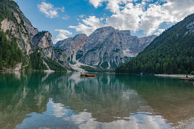 Scenic view of lake by mountains against sky