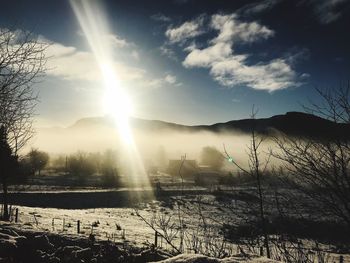 Scenic view of field against sky during winter