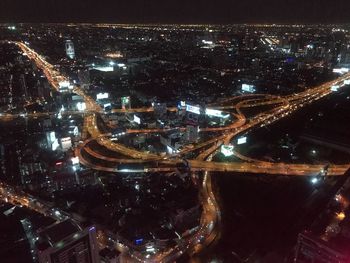 High angle view of illuminated buildings in city at night