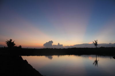 Scenic view of lake against sky during sunset