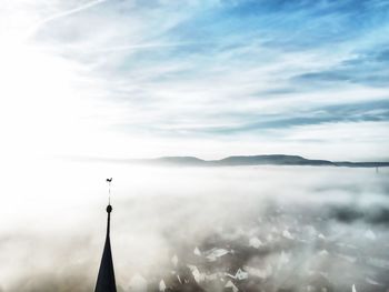 Aerial view of buildings against cloudy sky