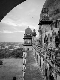 The black and white side view of an historical tomb  of gol gumbaz.. 