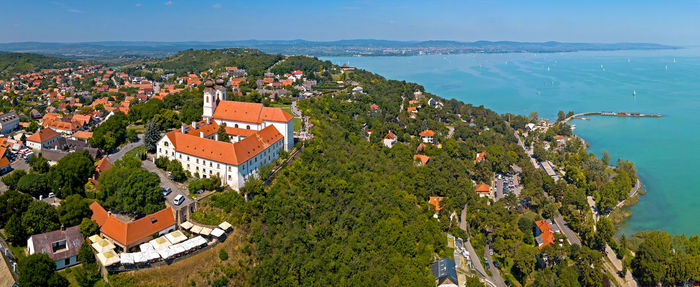 High angle view of townscape by sea against sky