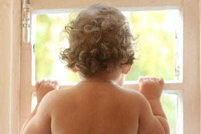 Rear view of shirtless man at home