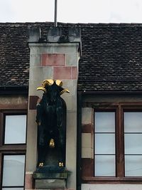 Low angle view of statue against building