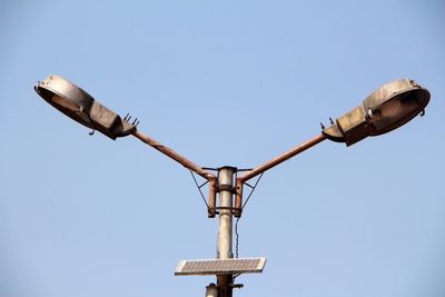 Low angle view of street light against clear blue sky