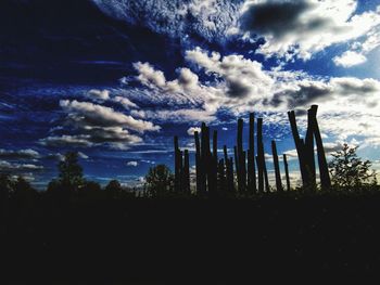 Low angle view of silhouette trees on field against sky
