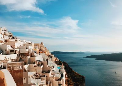 Townscape by sea against sky