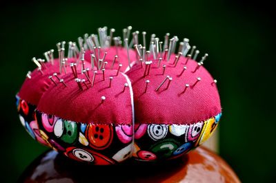 Close up of pin cushion against black background