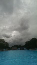 Scenic view of river against cloudy sky