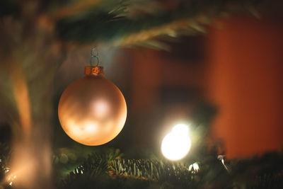 Close-up of illuminated christmas lights hanging at night