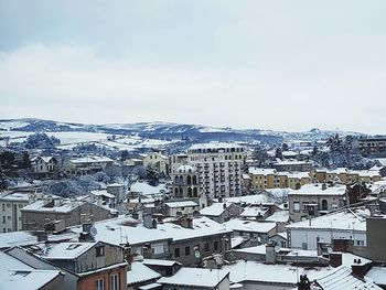 Aerial view of city against sky during winter