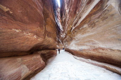 Person walking amidst rock formations