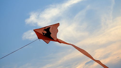 Low angle view of flag hanging against sky