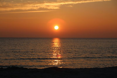 Scenic view of sea against romantic sky at sunset