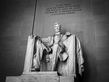 Low angle view of statue against wall