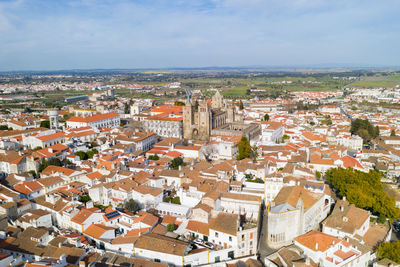 Evora drone aerial view on a sunny day with historic buildings city center in alentejo, portugal