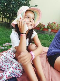 Portrait of a smiling girl sitting on grass