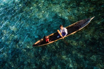 High angle view of woman sitting on boat in sea