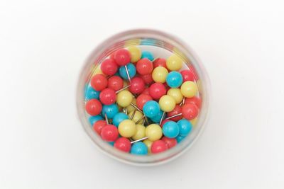 High angle view of colorful candies against white background