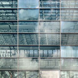 Low angle view of glass building against sky