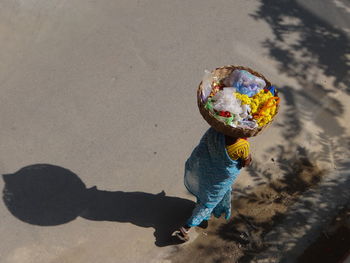 High angle view of market vendor walking on street