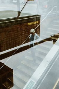 Man working on glass window of building