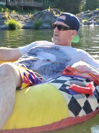 Portrait of young man sitting in lake