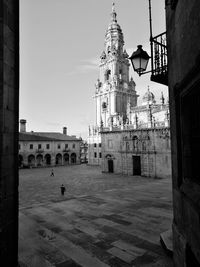 Cranes in city against sky