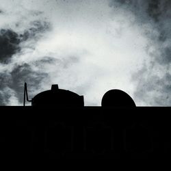 Low angle view of built structure against cloudy sky