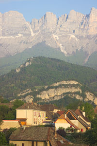 Scenic view of landscape and houses against mountains
