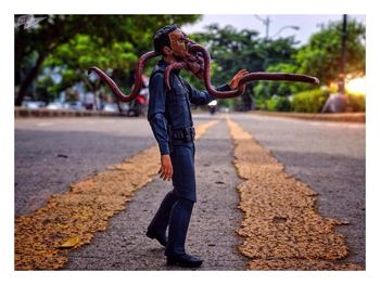 Rear view of woman walking on road