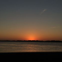 Scenic view of sea against clear sky during sunset