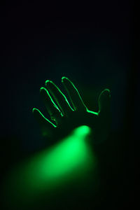 Low angle view of woman against black background