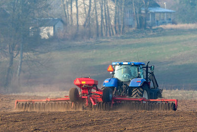 Tractor working with cultipacker rollers on the field