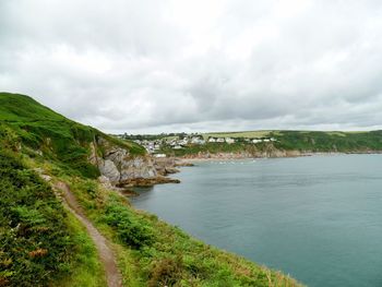 Scenic view of sea and coast against sky