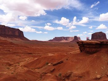 Rock formations on landscape against cloudy sky