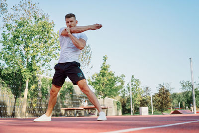 Full length of man exercising on road