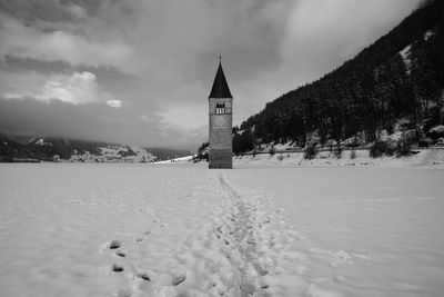 Clock tower against sky during winter