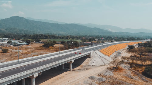 High angle view of road by mountains against sky