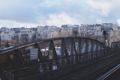 View of railroad bridge against cloudy sky