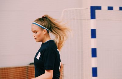 Side view of young woman in sports clothing