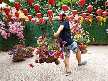 Man standing by flowering plants