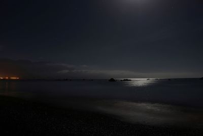 Scenic view of sea against sky at night