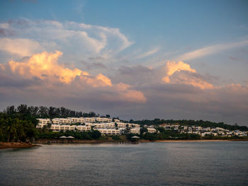 Scenic view of sea and resorts against sky during sunset