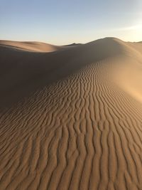 Scenic view of desert against sky during sunset